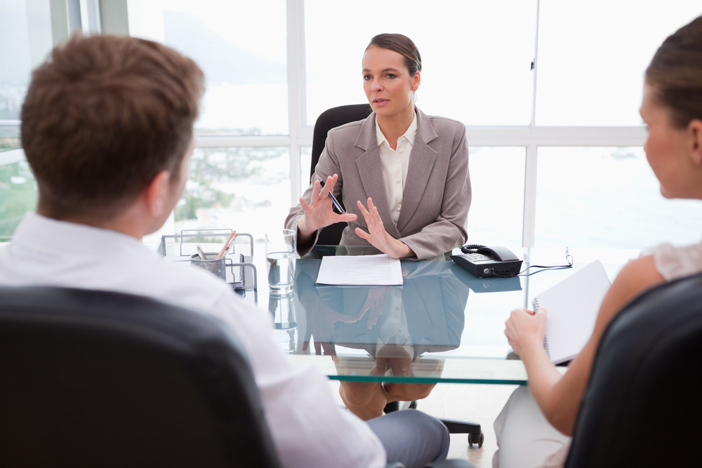 Lawyer explaining legal situation to her clients-1